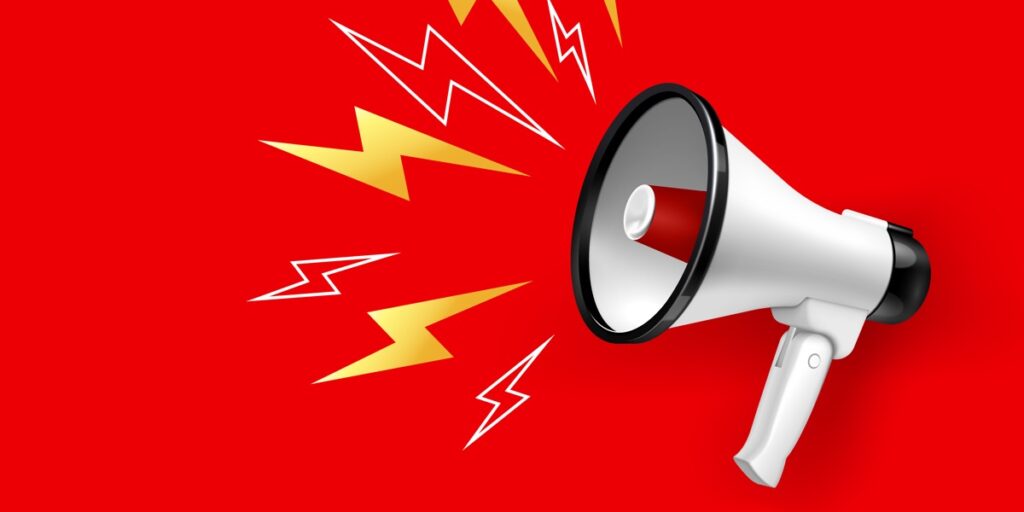 A white megaphone against a red background top represent setting up a PubMed alert