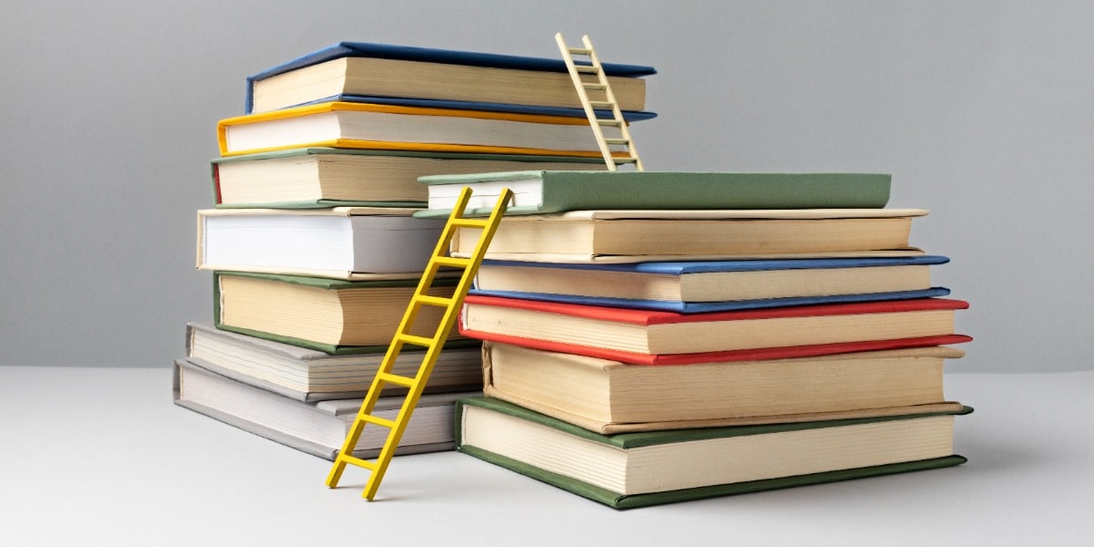 Reference Managers for Scientists represented by ladders against piles of books.