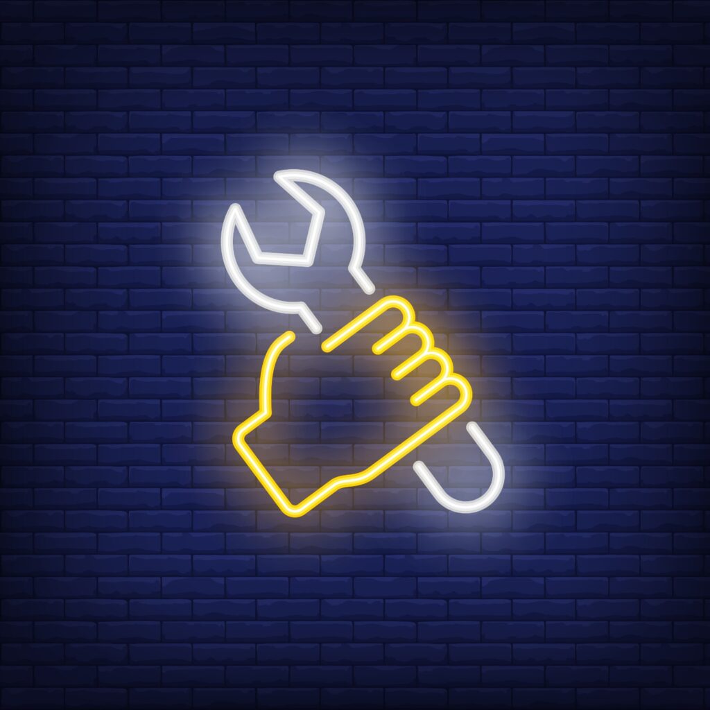 An image of a neon hand and spanner to depict MacGyver in the lab