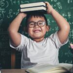 child stacking books on his head to represent a transfer stack and how to optimize your Western blot transfer