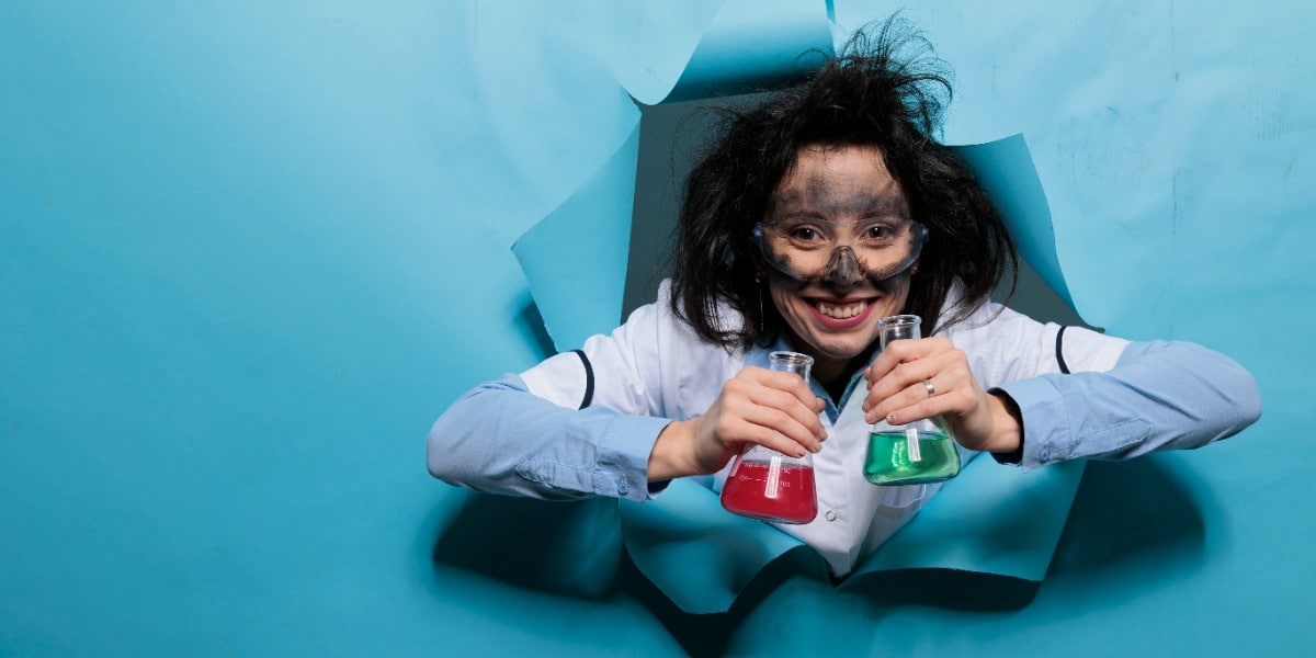 Scientist holding beakers showing how you can tell if you are a scientist