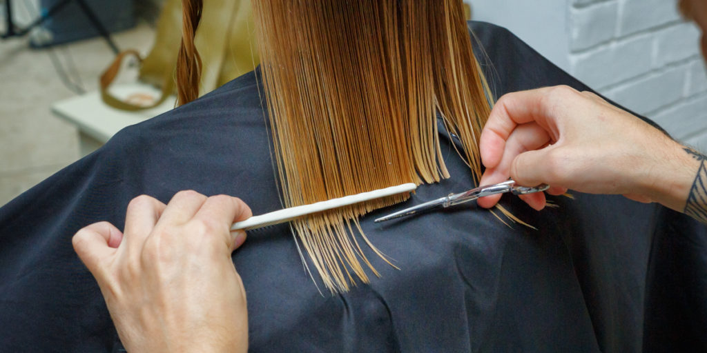 A person having their hair cut with straight edges to illustrate blunt-end cloning