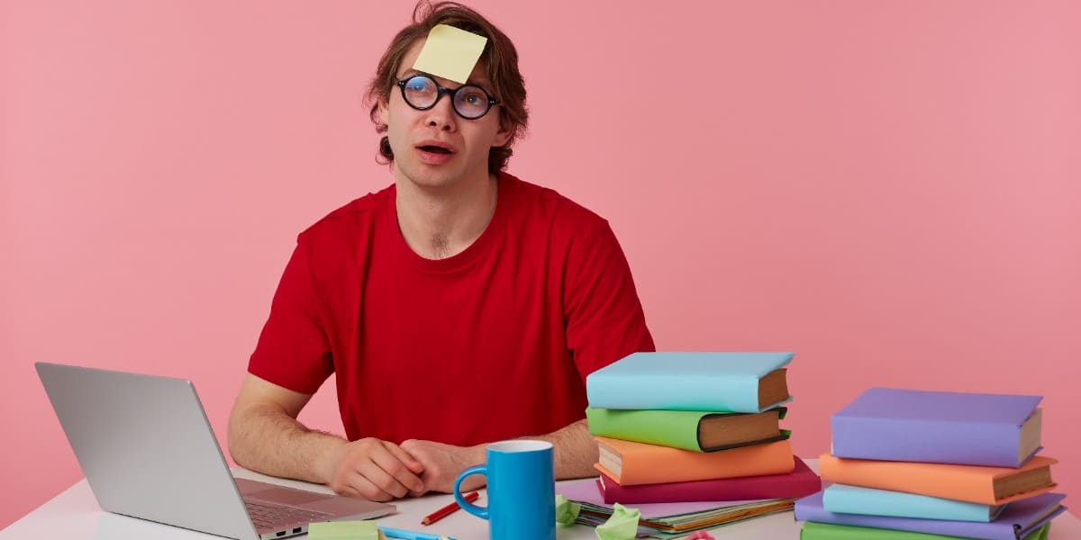 Image of man witch post-it on forehead, indicating the pain of creating a thesis outline