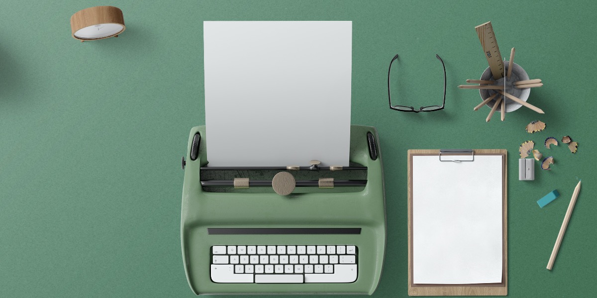 Image of typewriter and blank piece of paper to represent writing a scientific discussion