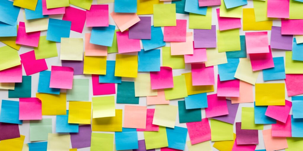 A board full of blank multicoloured sticky notes to represent planning your scientific paper