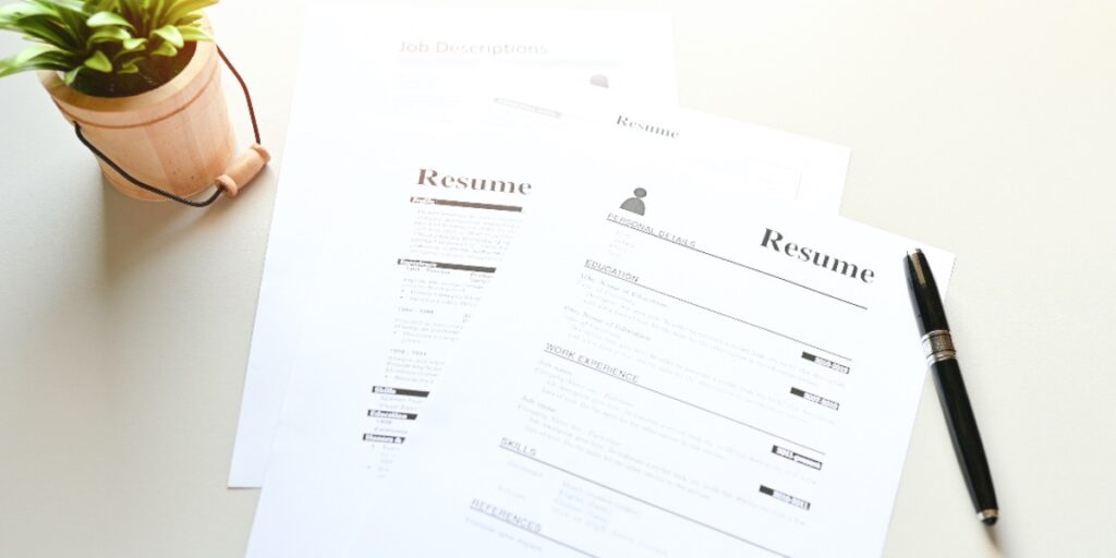 Resume and pen on a table to represent someone applying for alternative careers for scientists