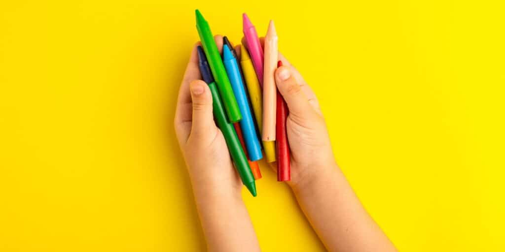 An image of a kid holding colorful pencils to depict using molecular visualization tools.