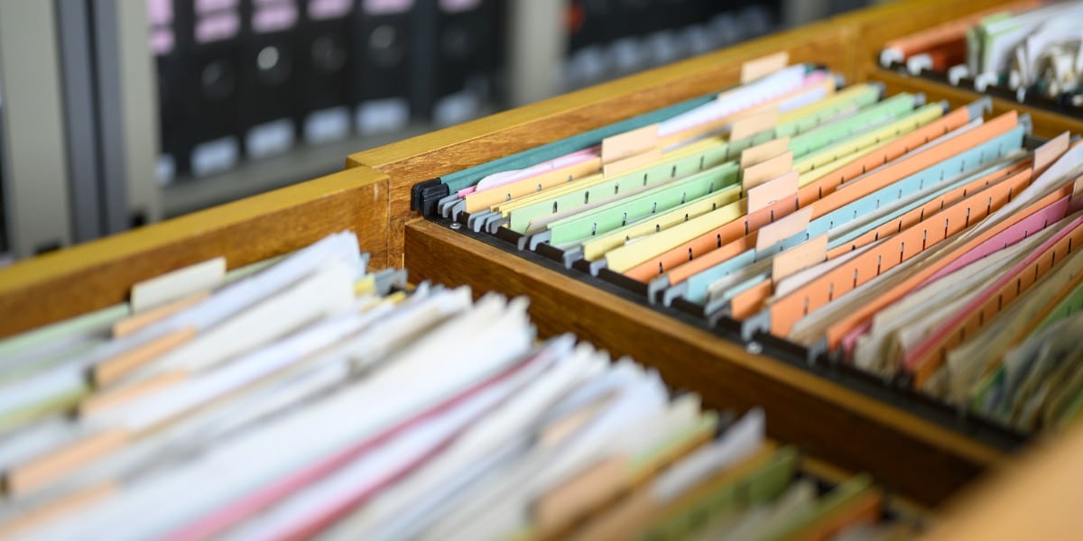 Image of a filing cabinet with open drawers and lots of coloured files to represent the reference manager EndNote