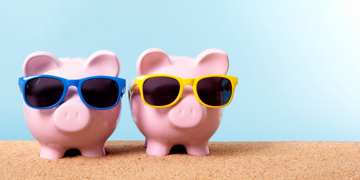 Two piggybanks on the beach wearing sunglasses to represent getting science research grants