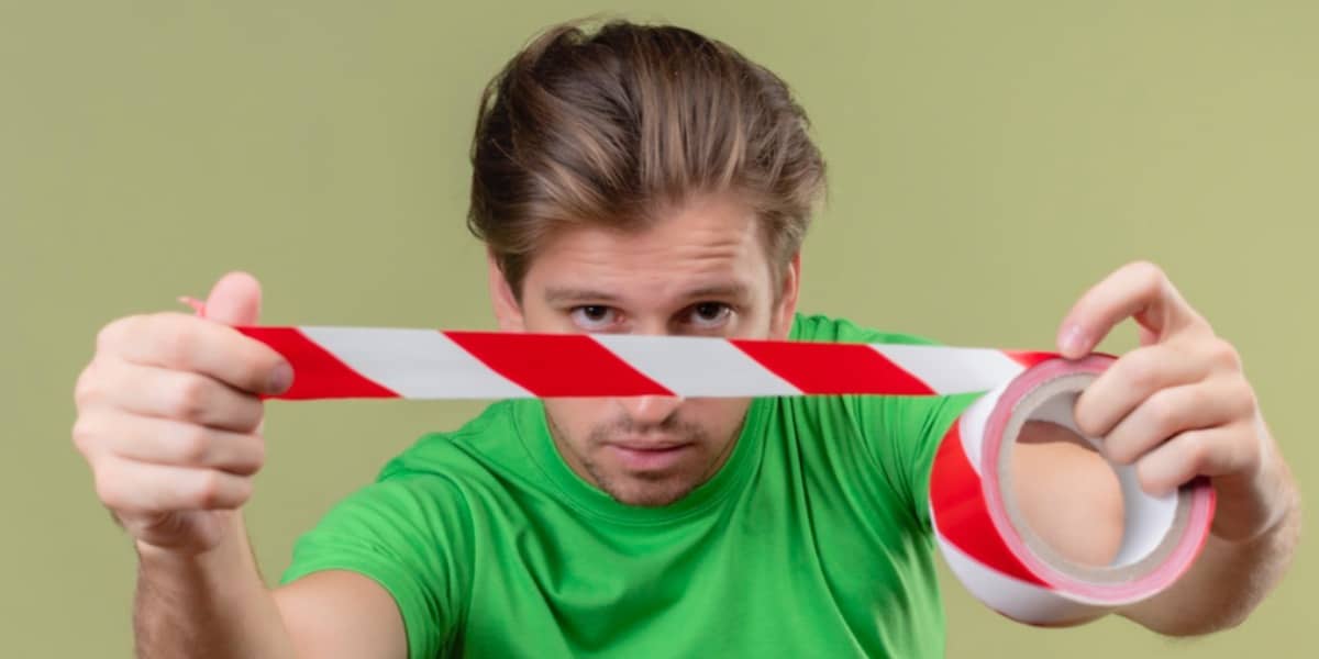 A man holding sticky tape to depict the process of DNA ligation