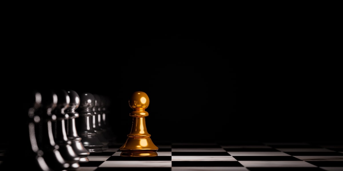 A golden pawn in front of black pawns in a chess game representing how chromatography works