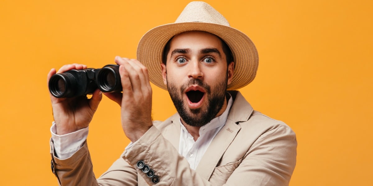 Shocked man with binoculars to represent the surprise when researchers learn what CRISPR cas13 can do