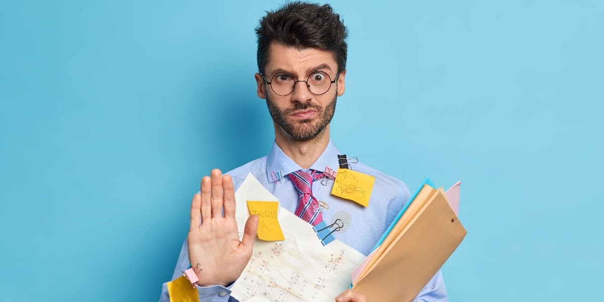 A man covered in notes and paper indicating under preparedness for journal club