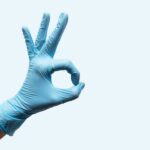 Gloved hand with OK symbol to show how a lab glove selection guide can help choose the perfect glove