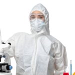 A scientist in full PPE looking happy because she has learned 12 tips for working in a biosafety cabinet