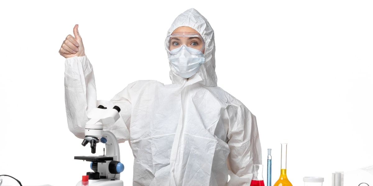 A scientist in full PPE looking happy because she has learned 12 tips for working in a biosafety cabinet