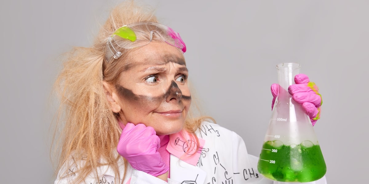 A girl looking at chemicals with explosion residue on her face because she didn't read the safety data sheet