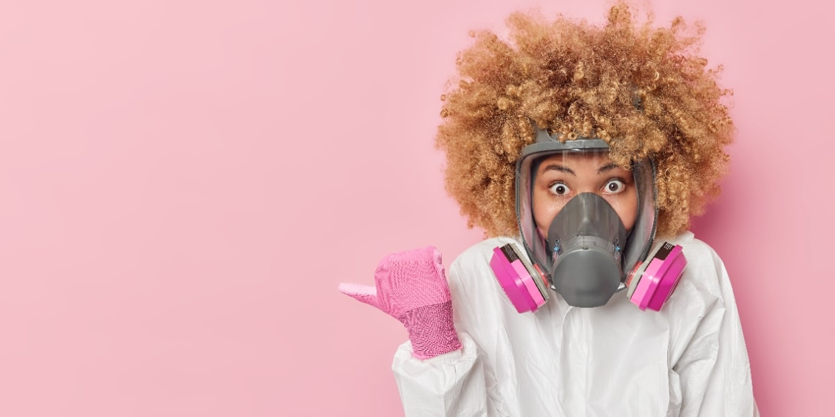 A girl in a gas mask pointing to this article: how to use a fume hood