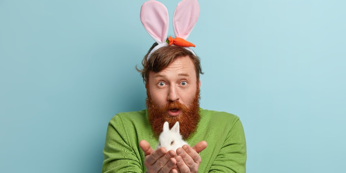 A man with rabbit hears holding a bunny as a visual illustration of genetic variants.