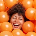 A woman surrounded by spheres to represent a purified molecule in the perfect protein purification buffer.