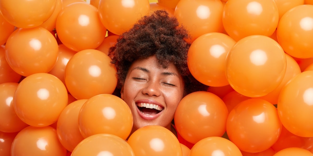 A woman surrounded by spheres to represent a purified molecule in the perfect protein purification buffer.