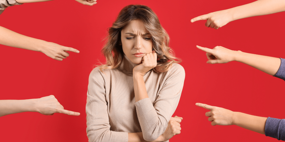 Person feeling blamed by pointing hands