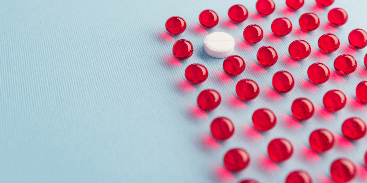 Red and white pills on blue background