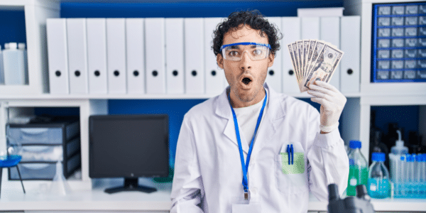 Surprised scientist holding cash
